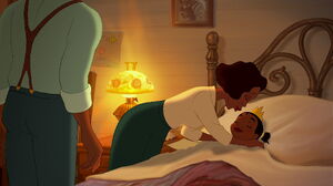 Tiana being kissed good night by her mother.