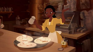 Tiana making beignets.