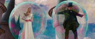 Oscar and Glinda descending down in their bubbles.