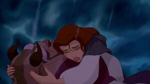 Belle cradling Beast's head, blaming herself for his predicament.