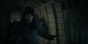 Joyce being held at gunpoint by Yuri.