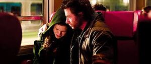 Rogue being comforted by Wolverine