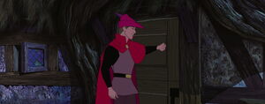 Phillip knocking on the cottage's door where a voice tells him to come inside.