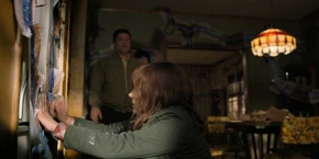 Joyce drawing a red X over Hopper's location so Bob can figure out where he is.