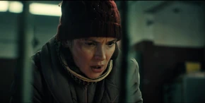 Joyce about to push another button which opens a door within the Demogorgon's pit.