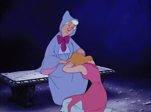 Cinderella being comforted by her Fairy Godmother.