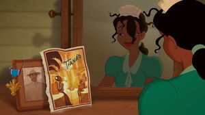 Tiana smiling fondly at a portrait of her late father.