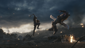 Captain America hits Thanos with Mjolnir.