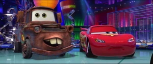 McQueen as Mater gets excited over hearing the drinks are free before he leaves in a hurry.