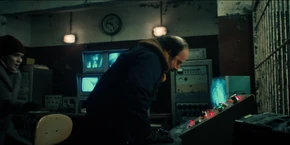 Joyce and Murray looking at the control panel as they are left to figure how to operate it in order to save Hopper.