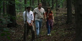 Joyce, Hopper, and Alexei walking through the forest.