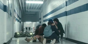 Lucas, Dustin, and Mike picking up a weakened El as the agents go to fight the Demogorgon.