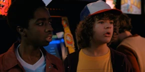 Lucas and Dustin looking at Mike when Keith demands him to set up a date between him and Nancy.