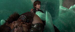 Hiccup removing some rubble off his father's body.