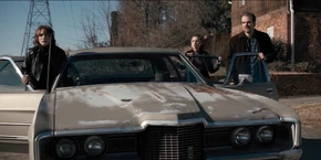 Later, Joyce, Nancy, and Hopper see government agents surround the Wheeler home.