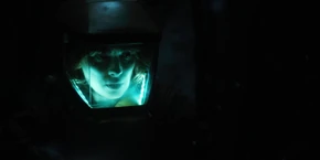 Joyce searching through the Upside Down version of the library.