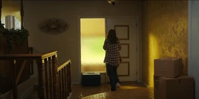 Joyce about to open the front door when she hears the doorbell ring.