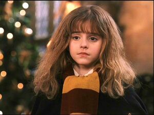 Hermione wearing her first Gryffindor scarf in year 1.
