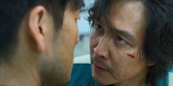 Gi-hun and Sang-woo argue