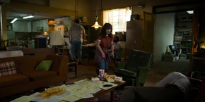 Joyce walking over to Alexei who's sleeping on the couch.