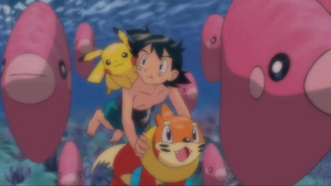 Buizel looks at Luvdisc with Ash and Pikachu.
