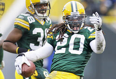 The Green Bay Packers' Atari Bigby (20) forces the Minnesota