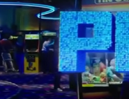 An image of a Pac-Man machine in the arcade.