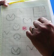 Concept art of  (1980), showcasing the earliest sprite sketches of Pac-Man.