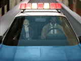 Aya and Daniel in a police car.