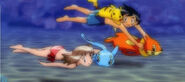May and Ash swim with their Pokemon