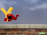 The letter Y flying Elmo around