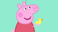 Peppa holds a rubber duck