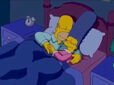 Homer and Marge Simpson are sleeping in bed