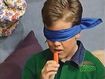 Stephen wears a blindfold as he eats a carrot