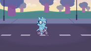 Snuffles riding a tricycle