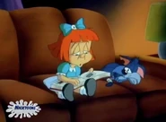 Elmyra looks through an album of her deceased pets