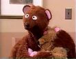 Curly Bear falls back asleep in Baby Bear's arms