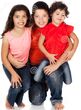 Three-caucasian-kids-two-girls-one-boy-all-wearing-blue-jeans-wearing-orange-red-pink-shirts-34175550