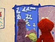 Elmo finds the Two Headed Monster sleeping at his door