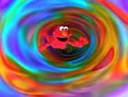 Elmo falls through a colorful vortex swirling tunnel to Grouchland