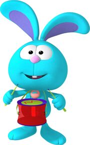 Raggles carrying a drum