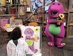 Kim finger paints a picture of Barney