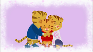 Daniel Tiger is hugging his mom and dad