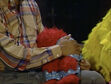 Elmo falls asleep on Gordon's lap to a bedtime story in episode 2460