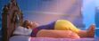 Ralph falls asleep as he lands on the bed in Snow White's dress
