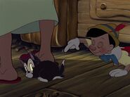 Figaro jumped after Pinocchio pet him