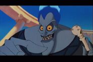 Hades holding a skull pacifier before attempting to put it into Baby Hercules27 mouth