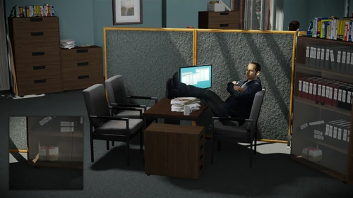 14. On the bottom shelf that is located between two desktops, in front of manager's office