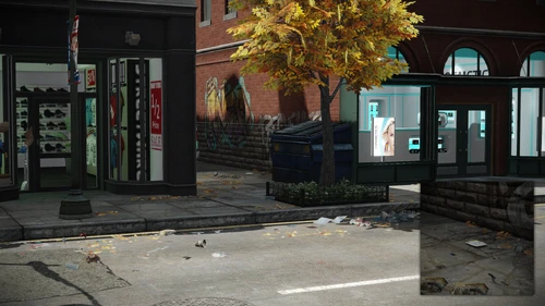 8. Next to the trash bin that is across the street, front of the main entrance