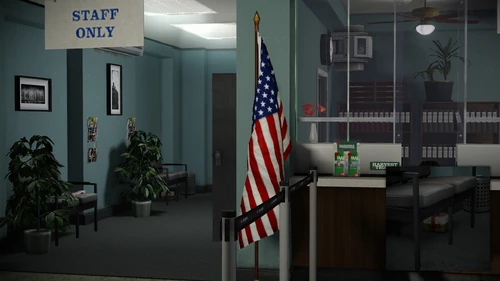 20. Below a pair of chairs, on the left side corridor when entering through the main entrance